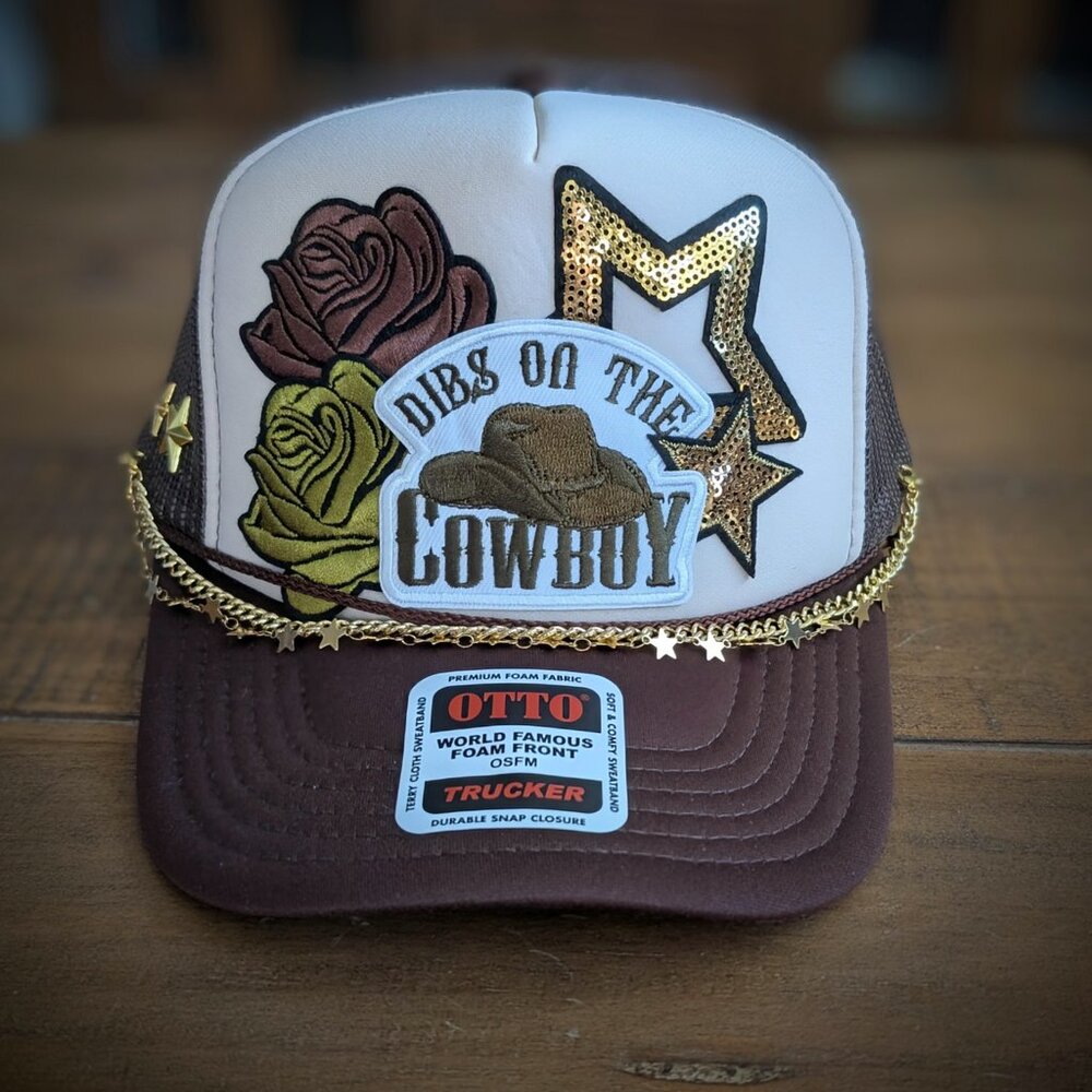 Trucker hat with iron on patches and embellishments
